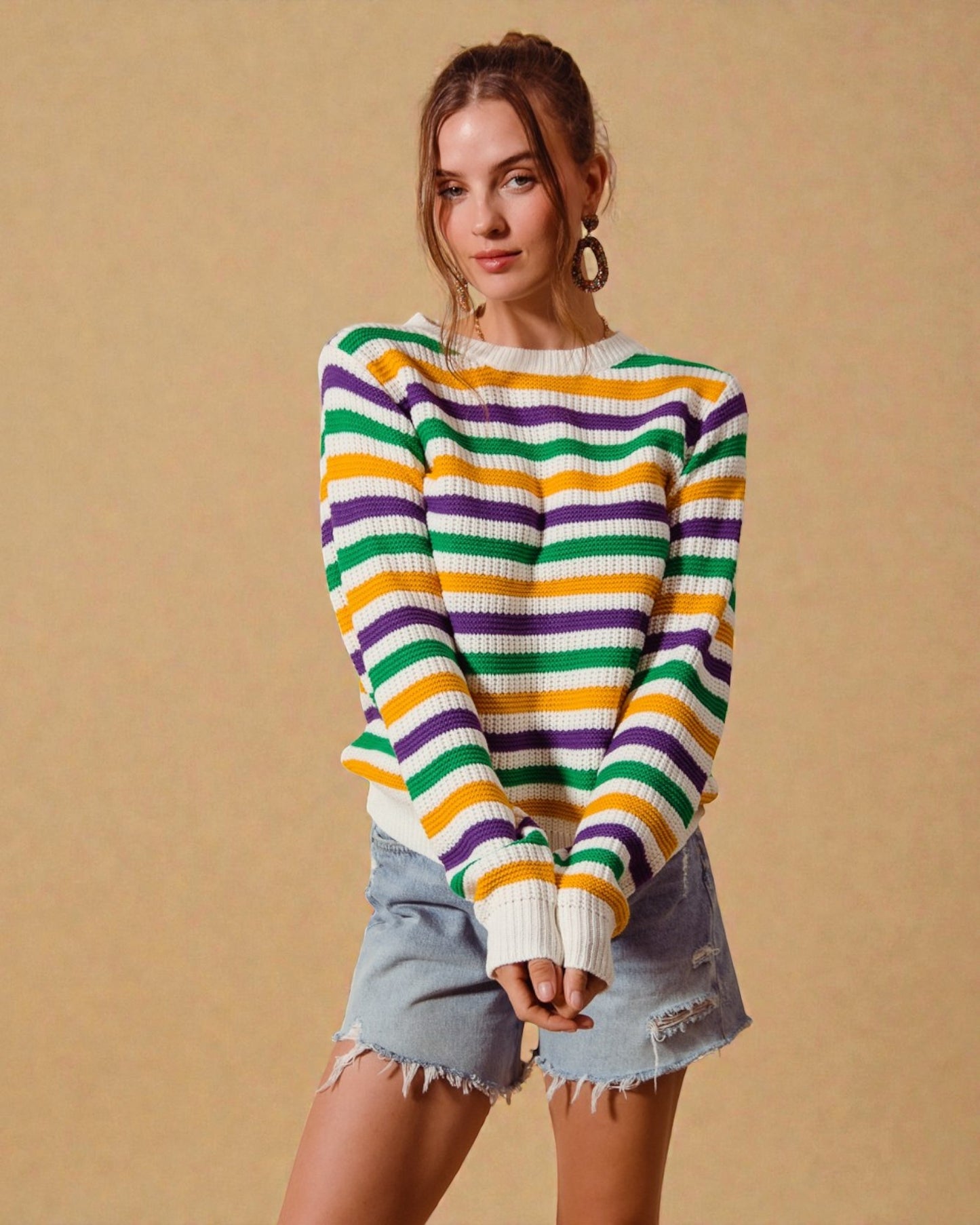 Woman wearing a colorful striped sweater against a beige background