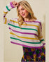 Woman wearing a colorful striped sweater against a plain background