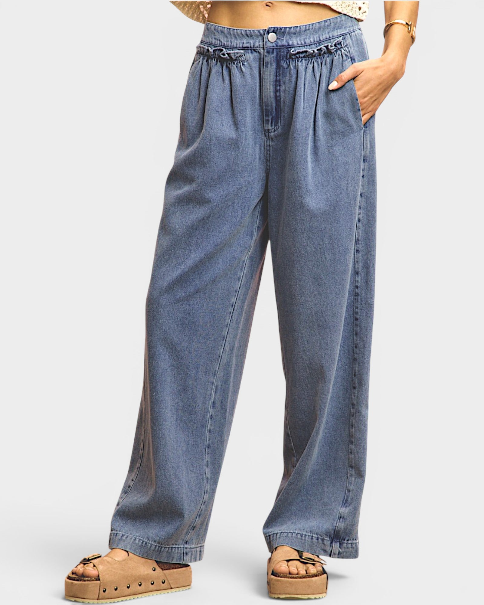 Blue denim pants worn by a person on a white background