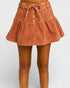 Brown corduroy skirt worn by a person on a plain background