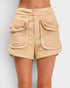 Beige shorts with large pockets on a plain background