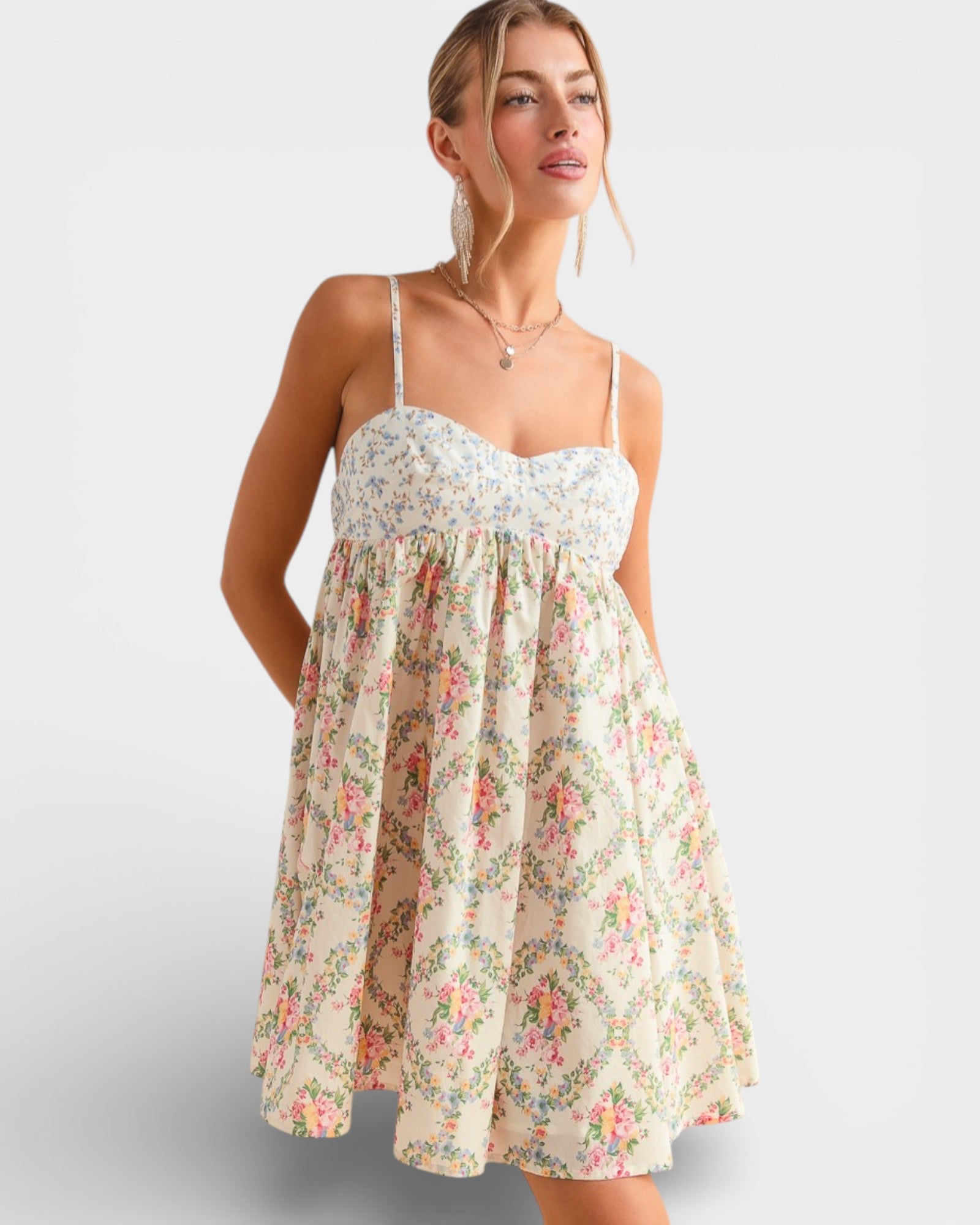 Woman wearing a floral dress on a plain background