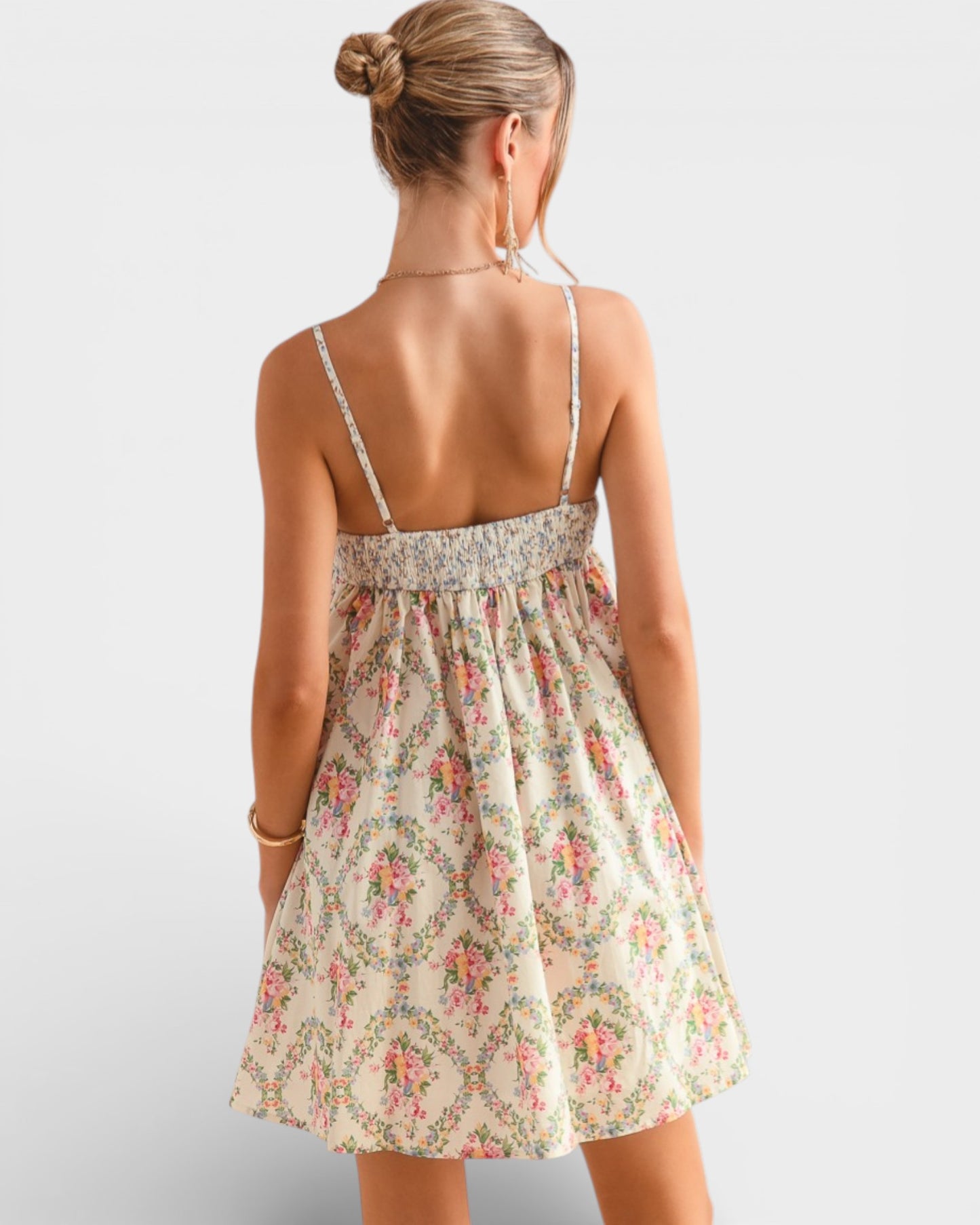 Woman wearing a floral dress on a plain background