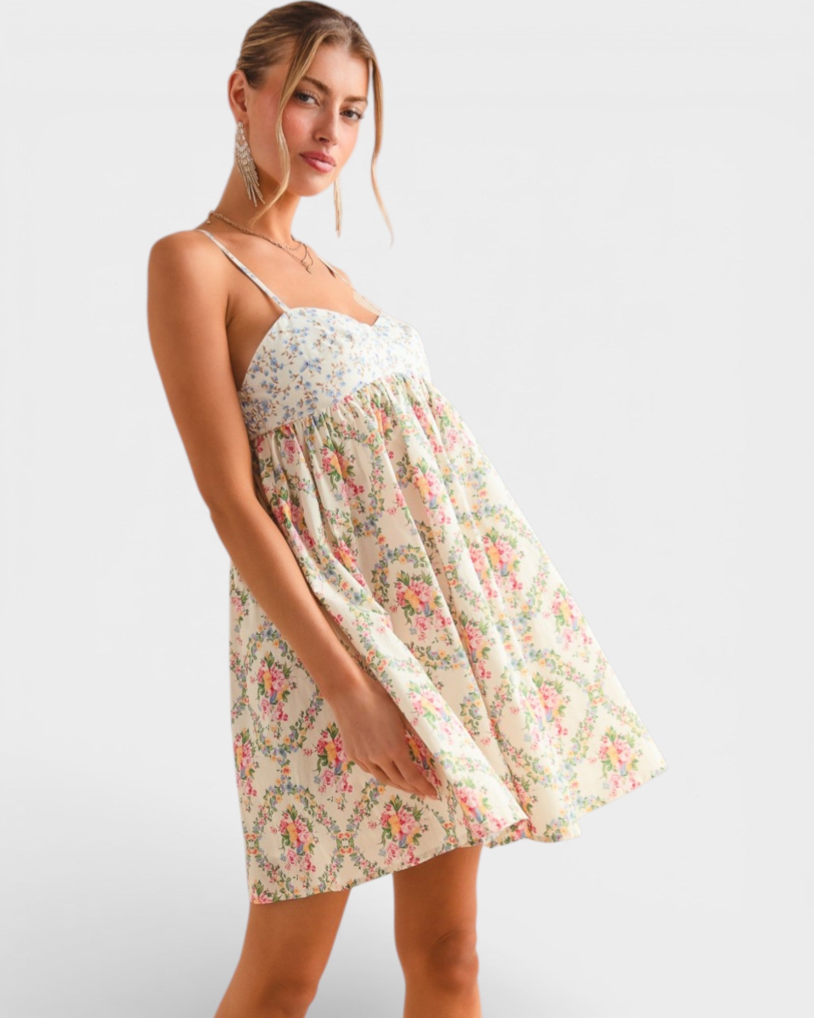 Woman wearing a floral dress on a plain background