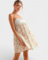 Woman wearing a floral dress on a plain background