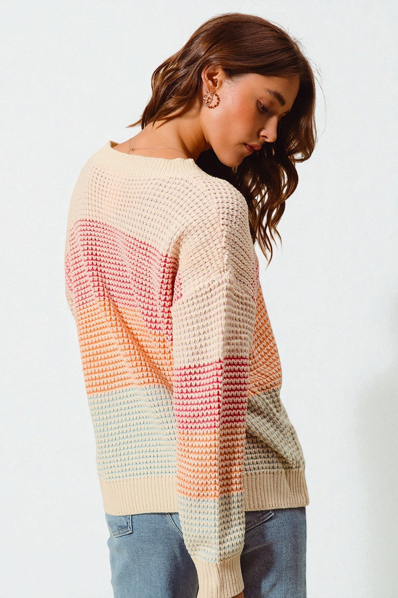 Woman wearing a colorful sweater with a white background