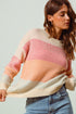 Woman wearing a colorful sweater with a gradient effect on a plain background