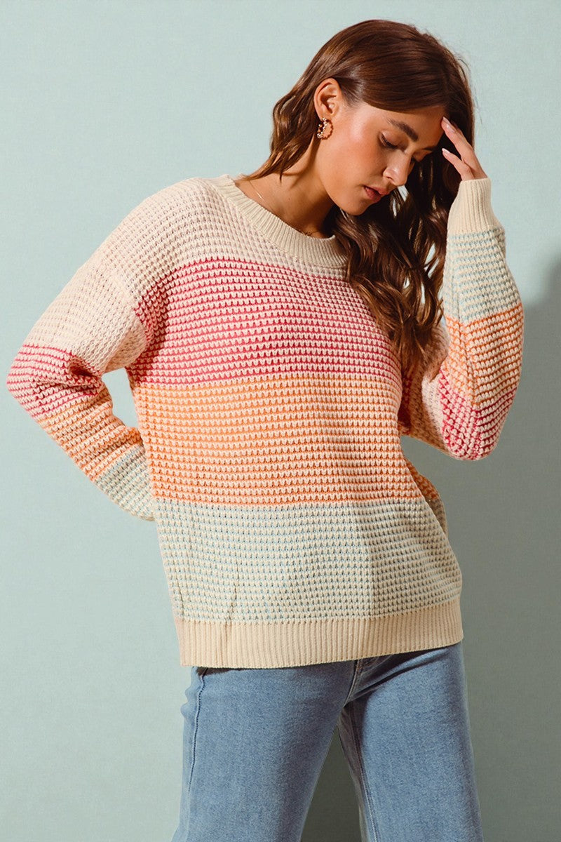 Woman wearing a colorful sweater with a light blue background