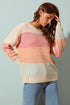 Woman wearing a colorful sweater with a light blue background