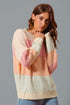 Woman wearing a colorful knit sweater against a gray background