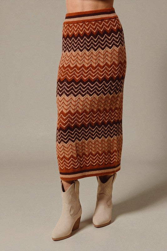 Patterned skirt worn with beige boots on a neutral background