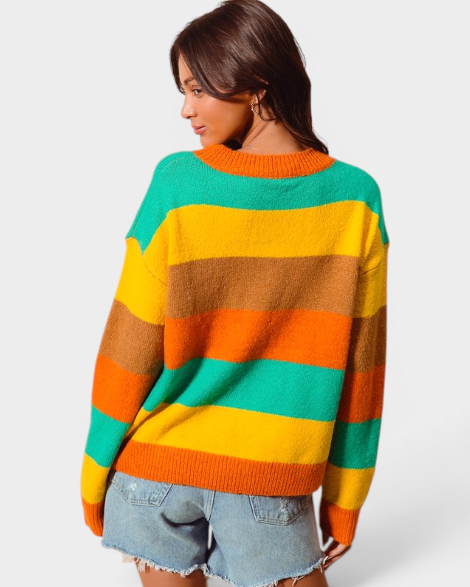 Person wearing a colorful striped sweater on a white background