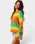 Woman wearing a colorful striped sweater on a plain background