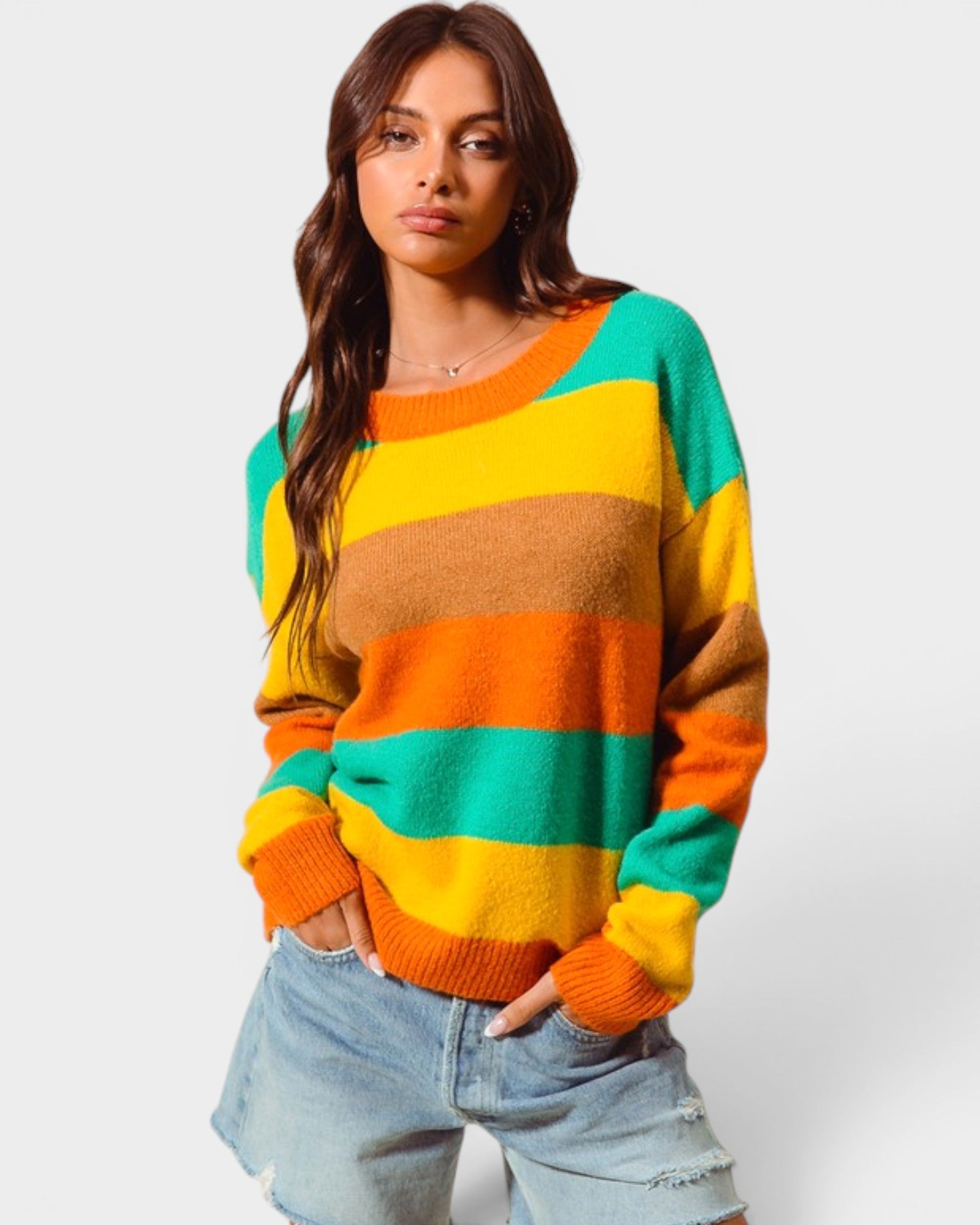 Woman wearing a colorful striped sweater on a white background