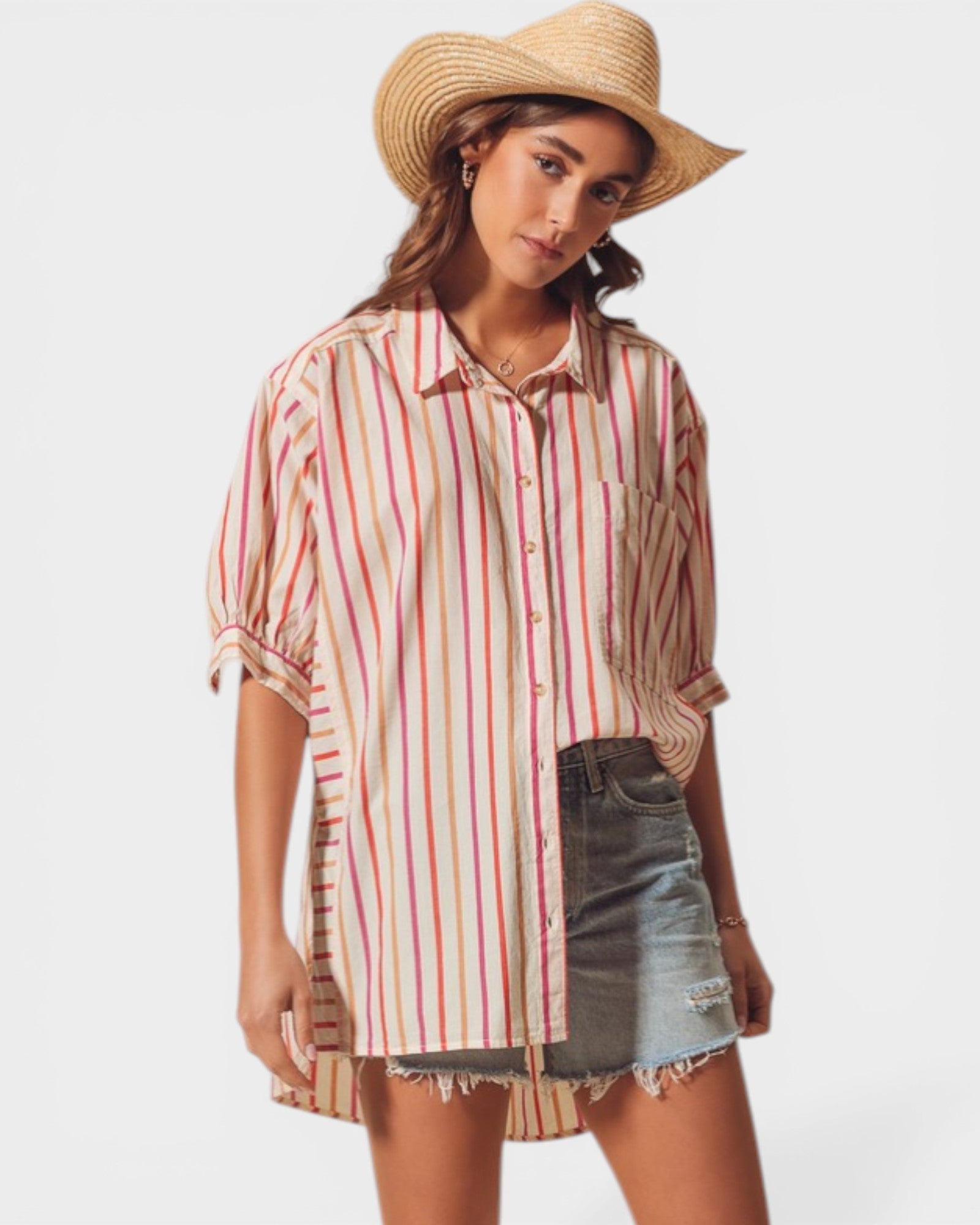 Woman wearing a striped shirt and straw hat on a plain background