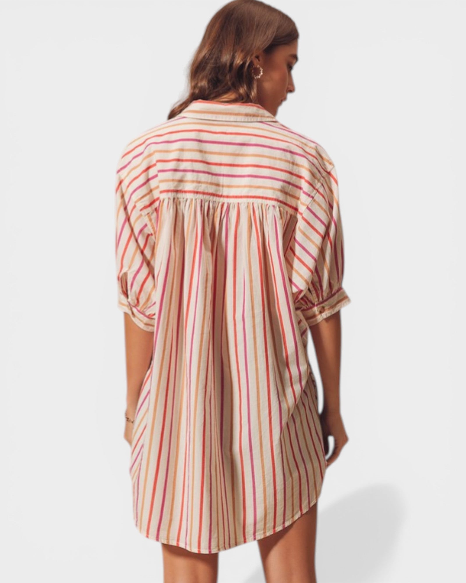 Woman wearing a striped shirt dress on a white background
