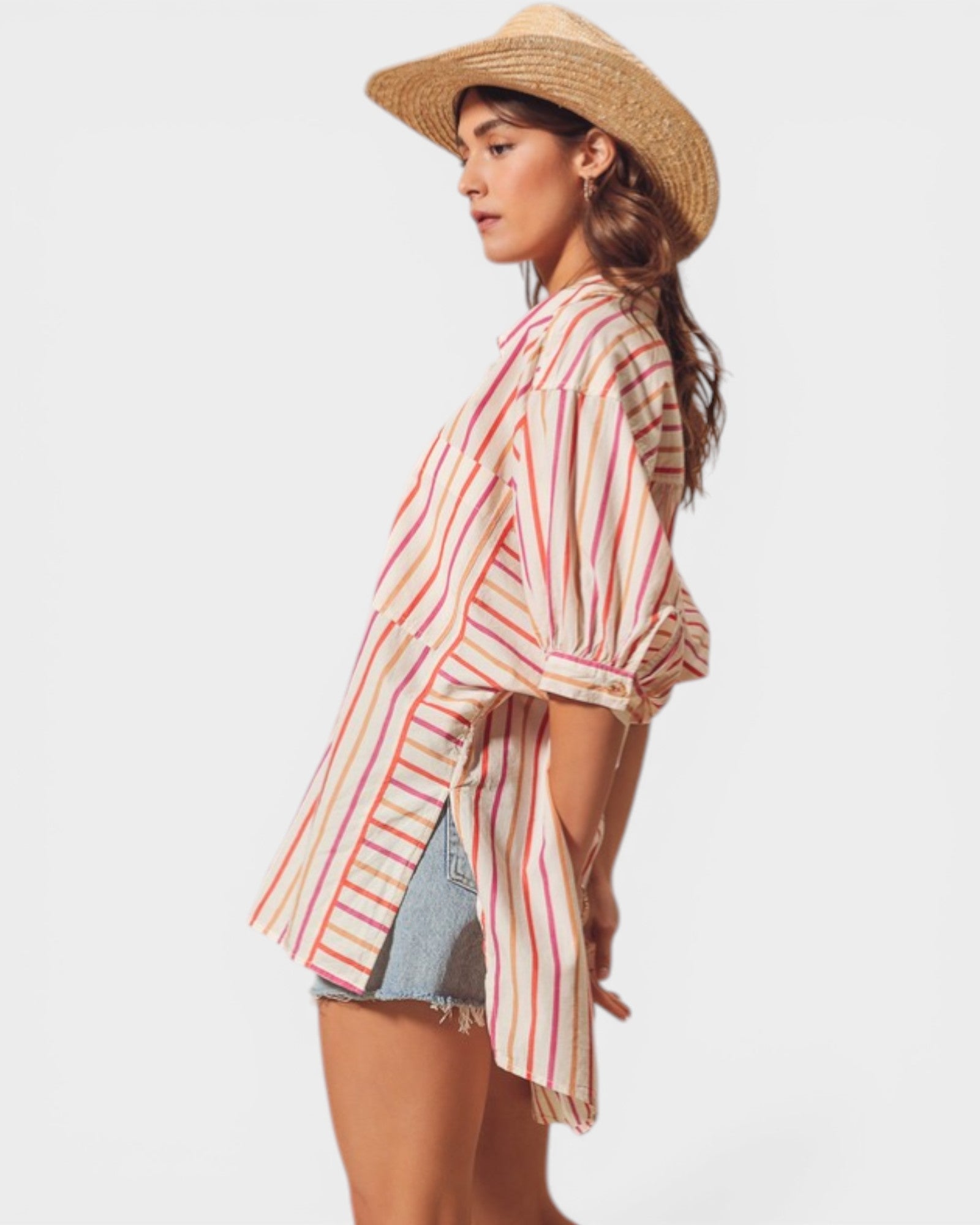 Woman wearing a striped shirt and straw hat on a white background