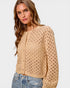 Woman wearing a beige open-knit cardigan on a white background