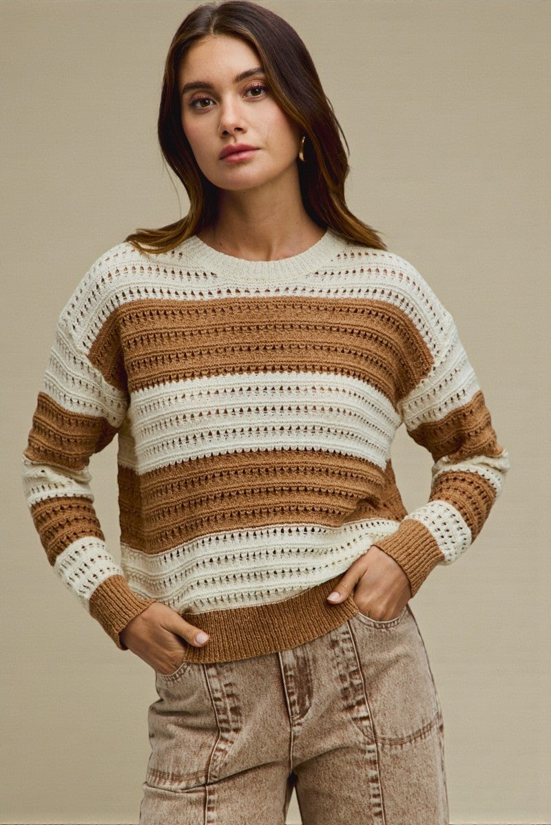 Woman wearing a patterned sweater against a neutral background