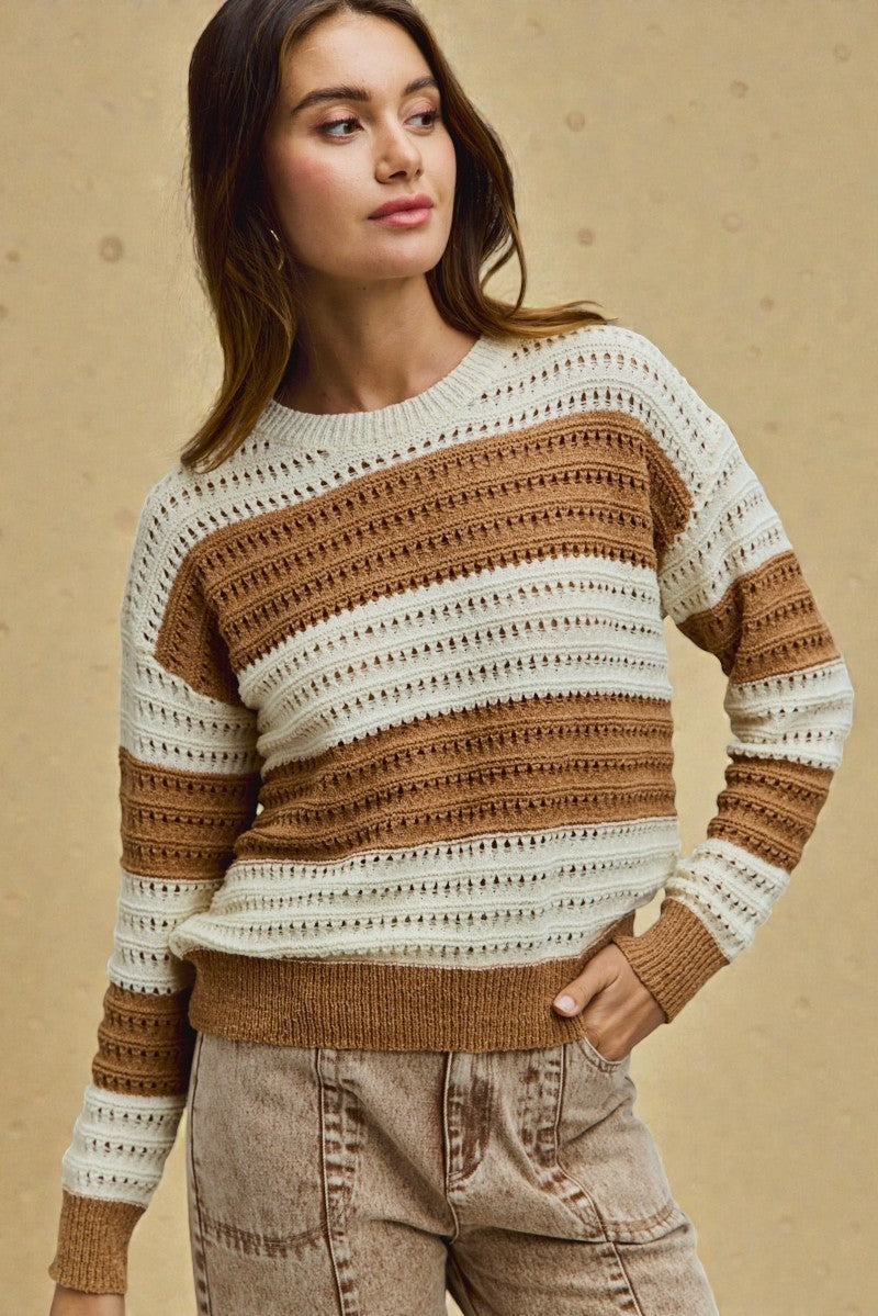 Woman wearing a patterned sweater against a beige background