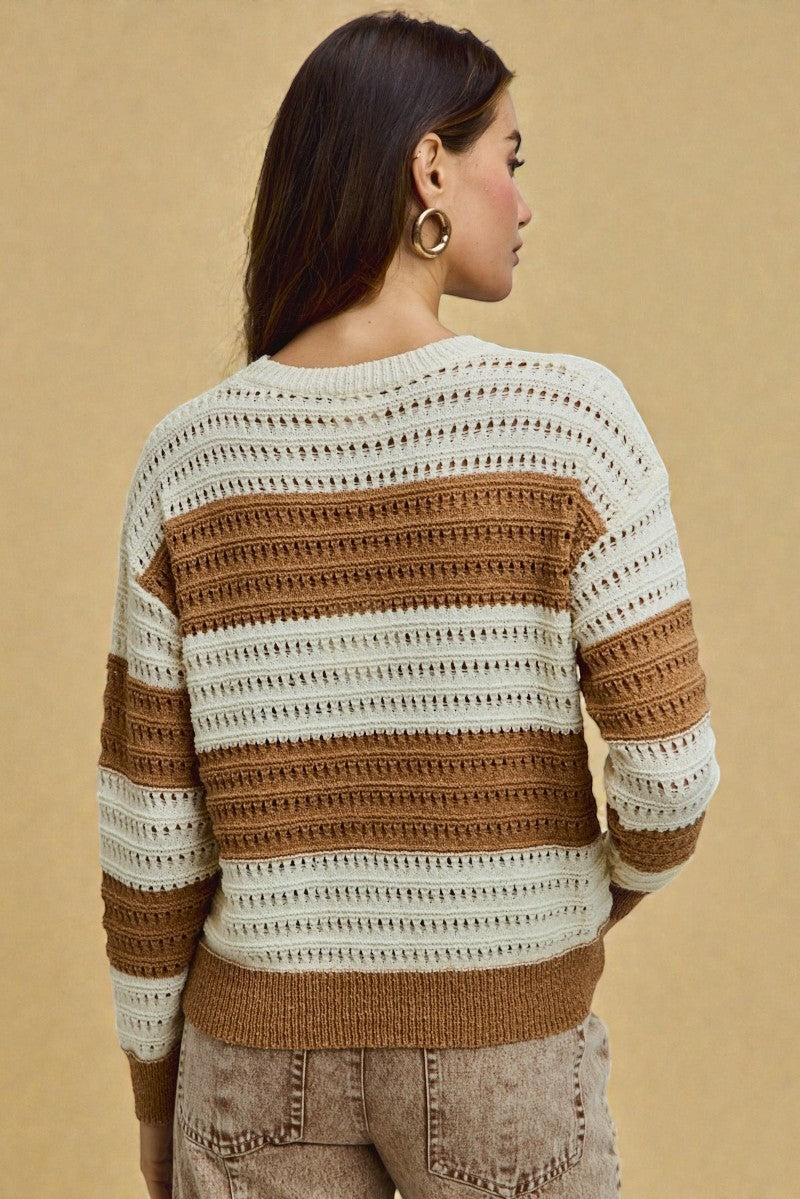 Woman wearing a striped sweater against a beige background
