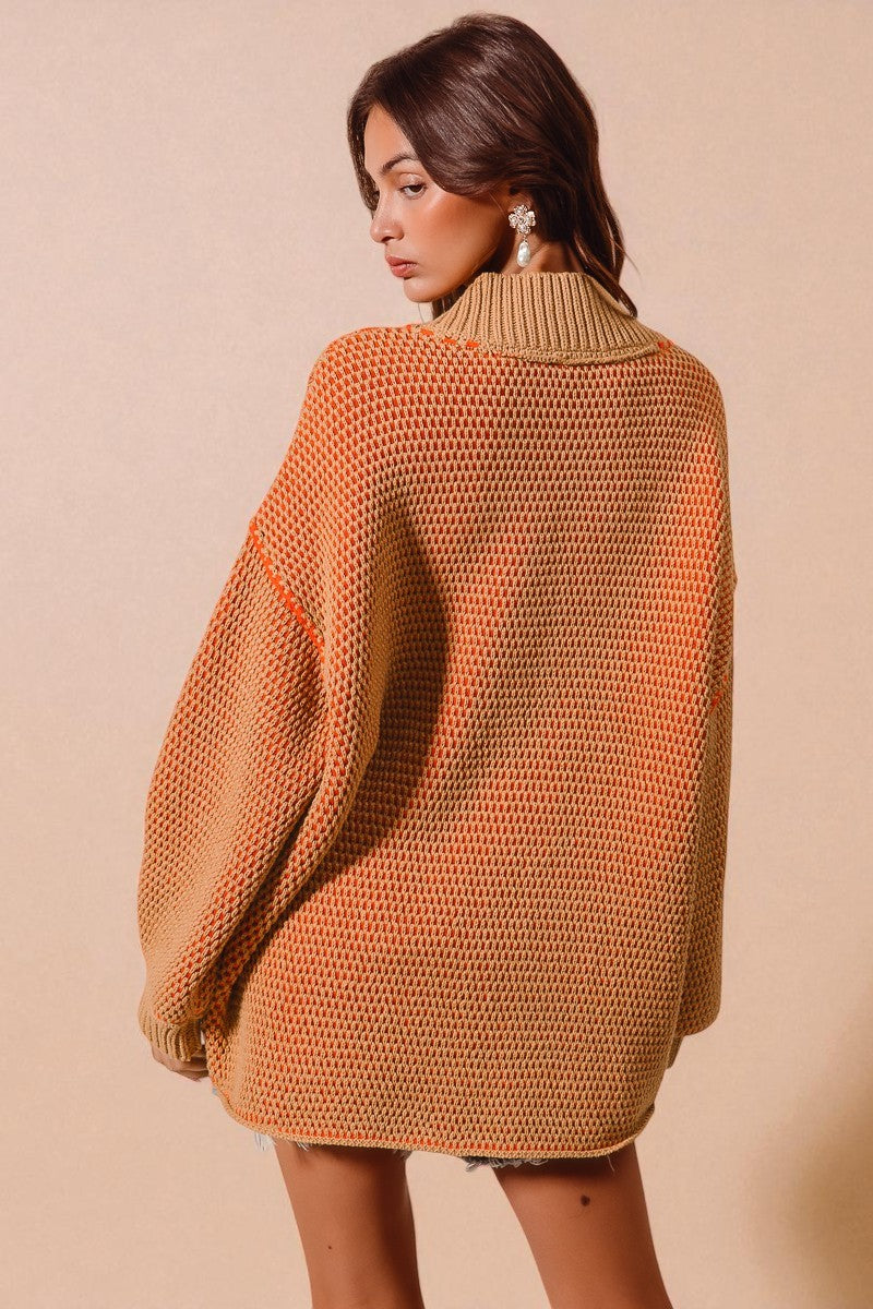 Woman wearing a brown knitted sweater against a beige background