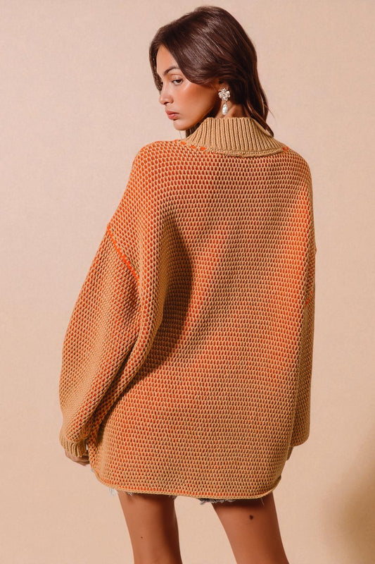 Woman wearing a brown knitted sweater against a beige background