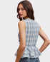 Woman wearing a blue plaid peplum top on a white background
