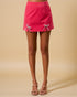 Pink skirt with bow details on a beige background