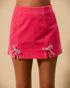 Pink skirt with bow details on a beige background