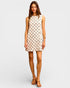 Woman wearing a sleeveless dress with a geometric pattern on a white background