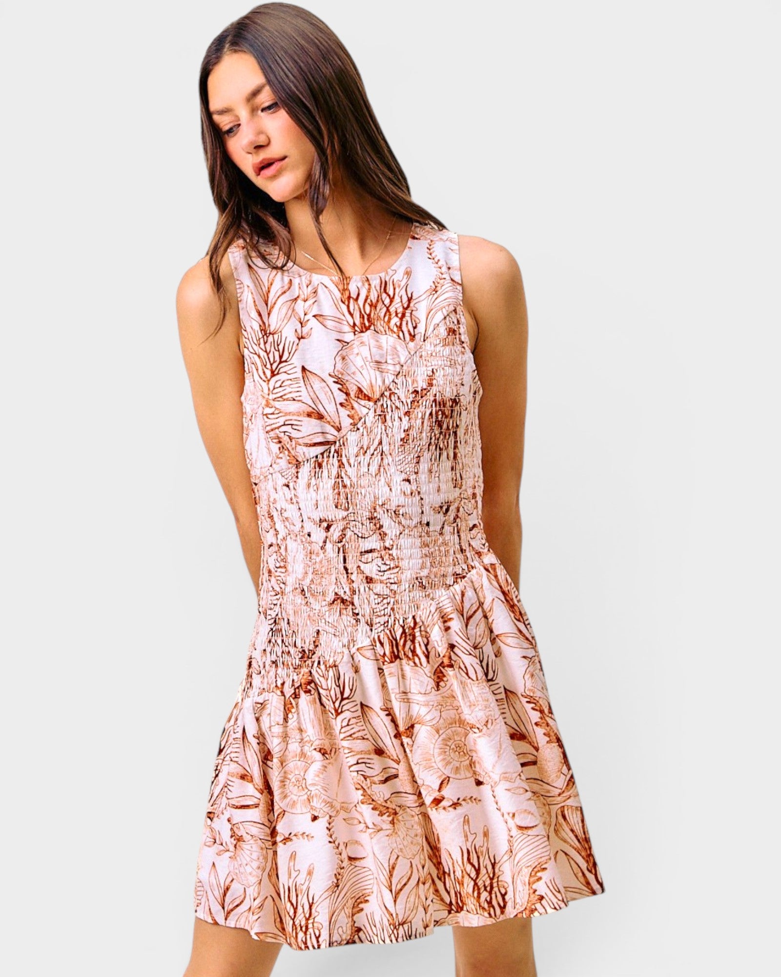 Woman wearing a floral dress on a plain background