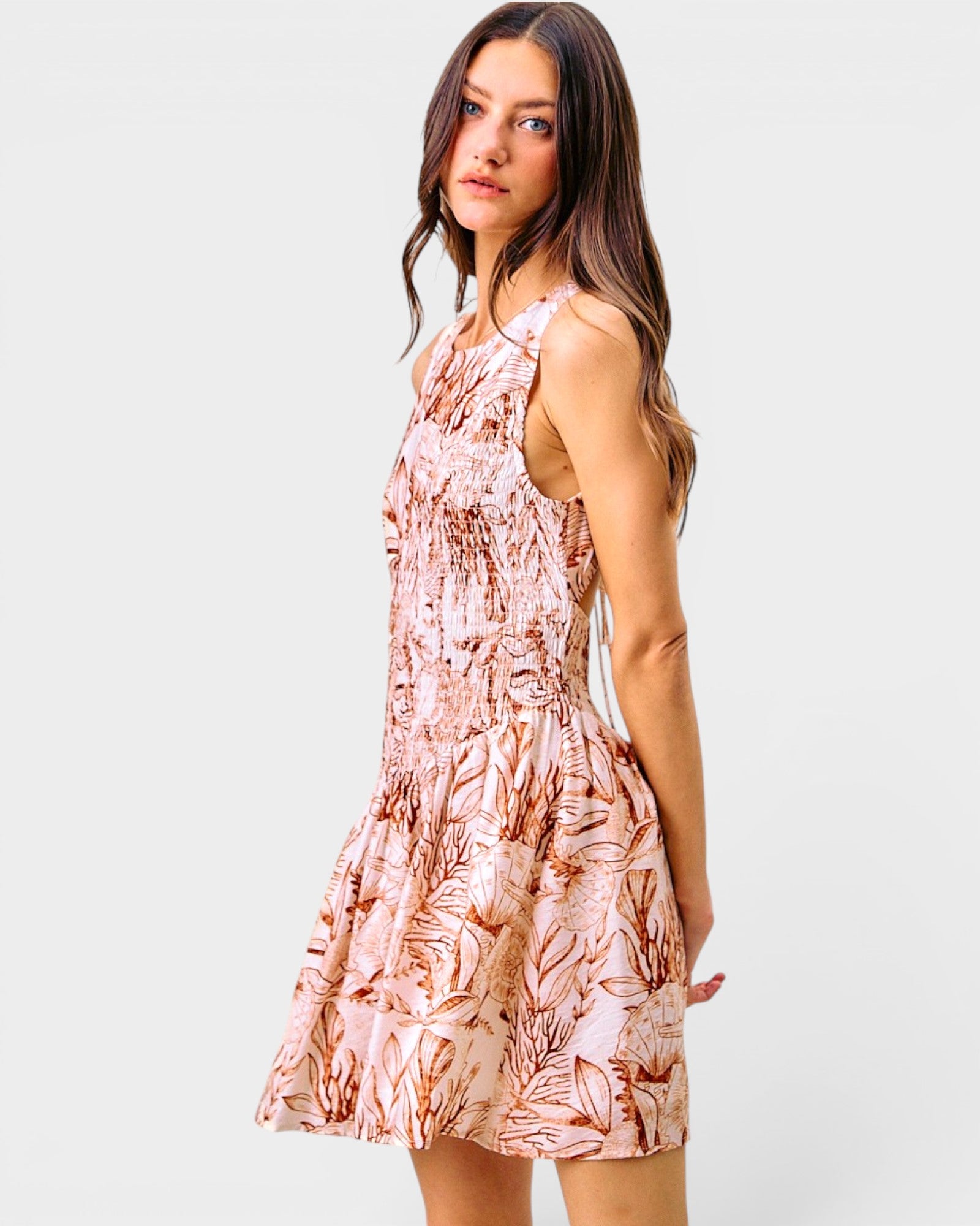 Woman wearing a floral dress on a plain background