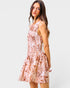 Woman wearing a floral dress on a plain background