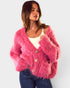 Woman wearing a pink fuzzy cardigan on a white background