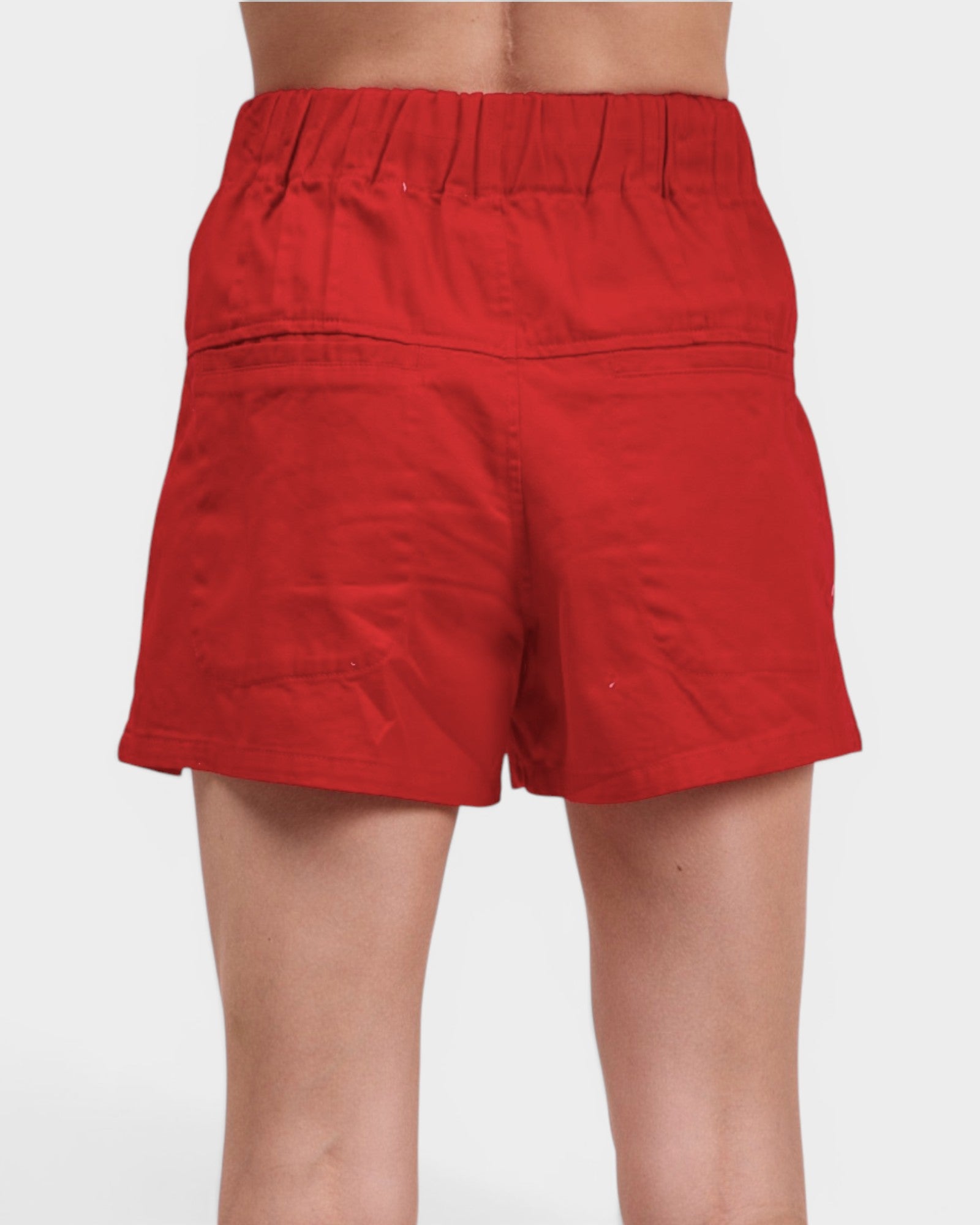 Red shorts worn by a person on a white background