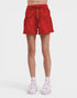 Red shorts worn by a person on a white background