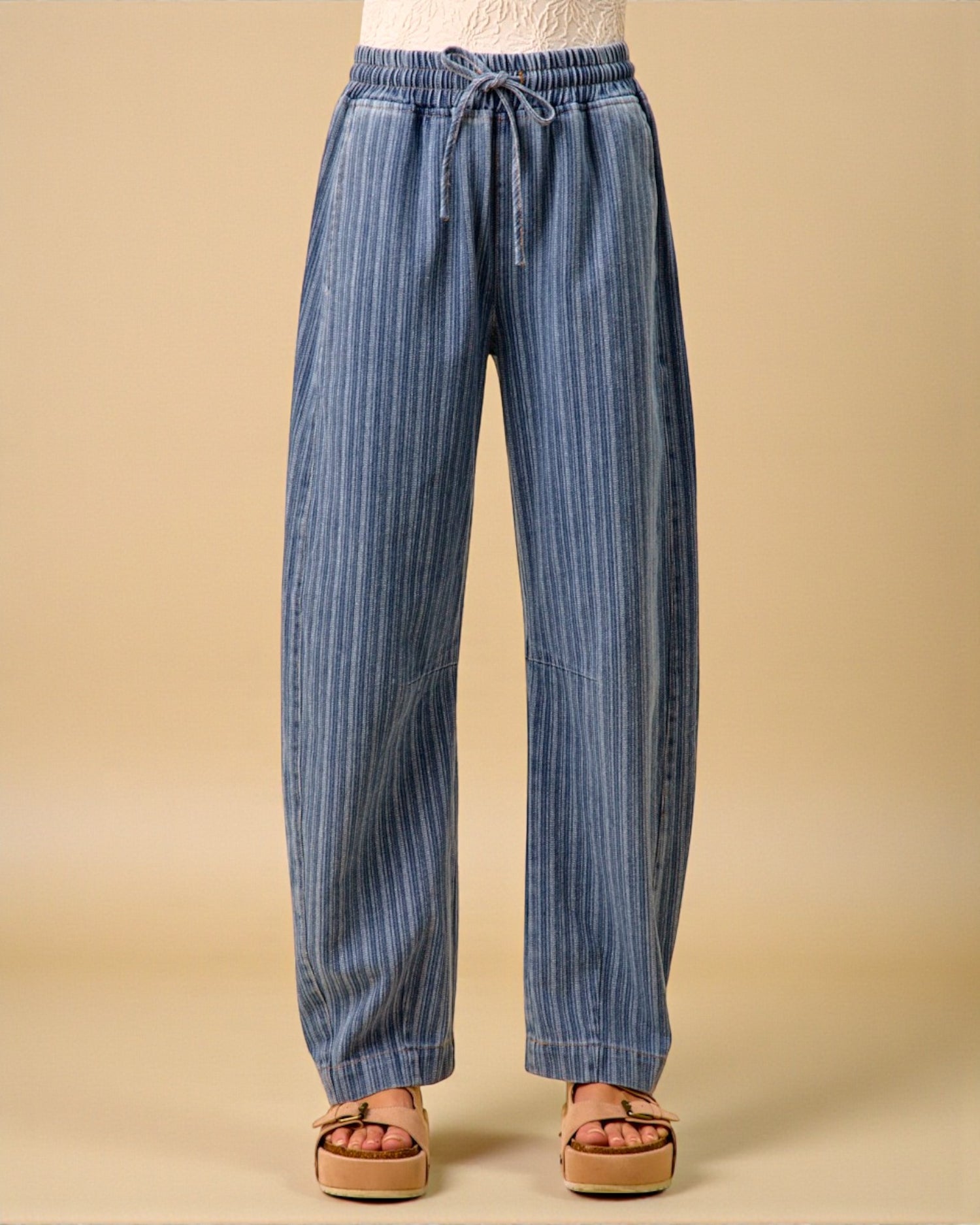 Blue striped pants on a beige background
