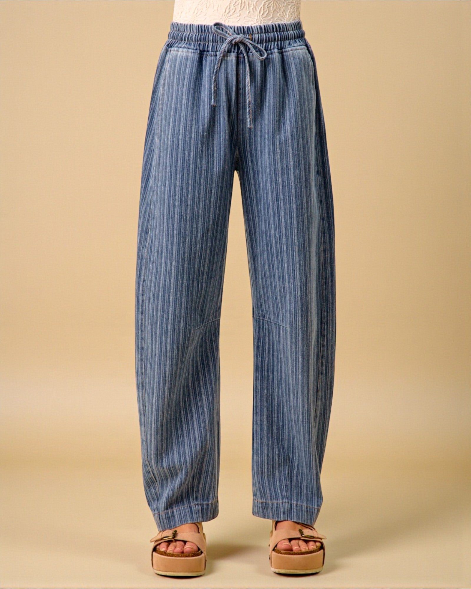 Blue striped pants on a beige background