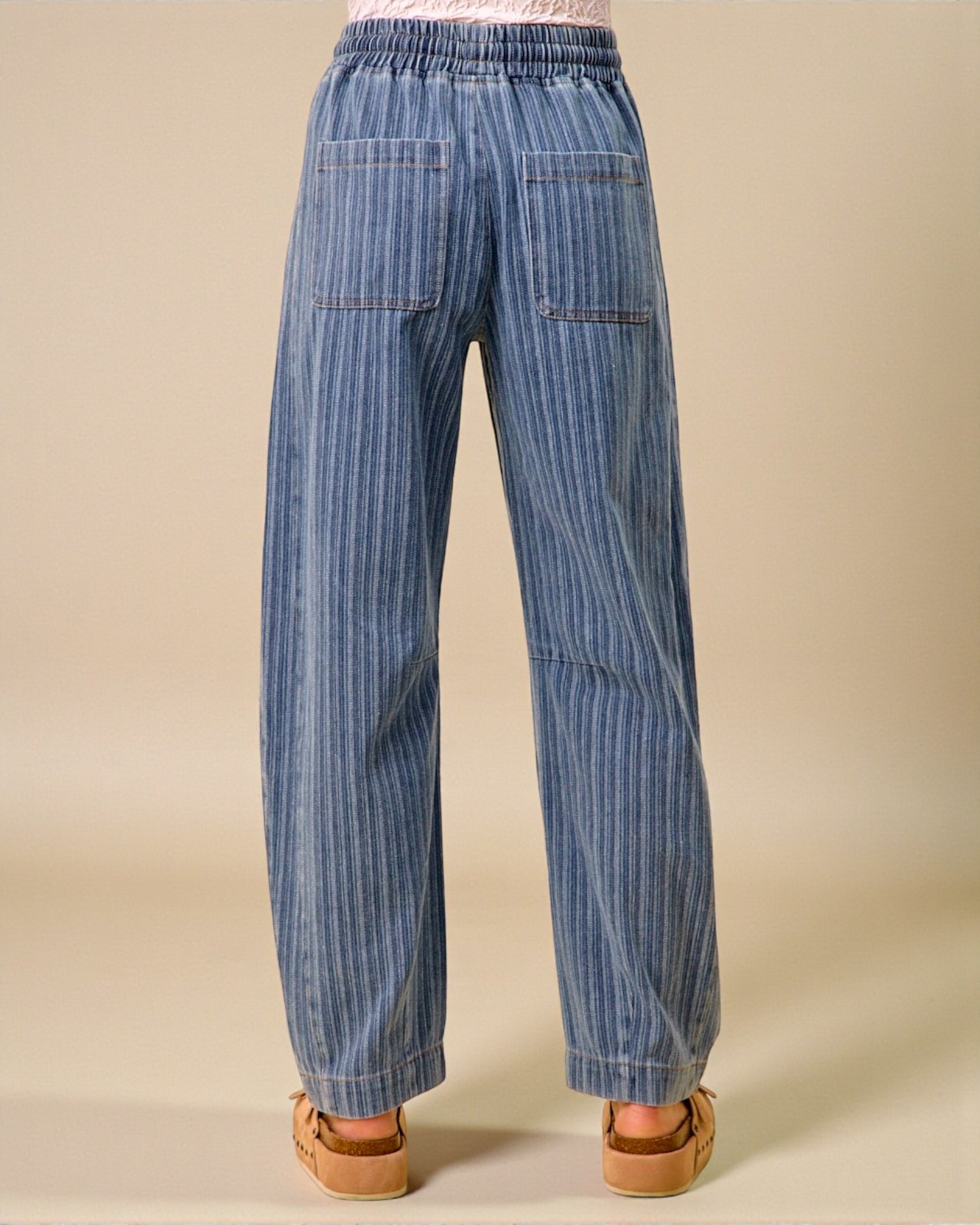 Blue striped pants on a beige background