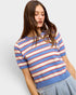 Woman wearing a blue, red, and white striped sweater on a light gray background