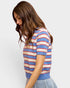 Woman wearing a striped sweater with a plain background
