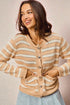 Woman wearing a beige and white striped cardigan against a plain background