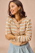 Woman wearing a beige and white striped sweater against a beige background