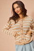 Woman wearing a beige and white striped cardigan against a beige background