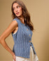 Woman wearing a blue striped sleeveless top against a beige background