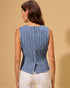 Woman wearing a blue striped sleeveless top against a beige background