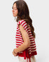 Woman wearing a red and white striped sleeveless top on a white background