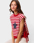 Woman wearing a red and white striped shirt with a star design on a plain background