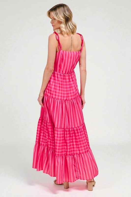 Woman wearing a pink gingham dress on a white background